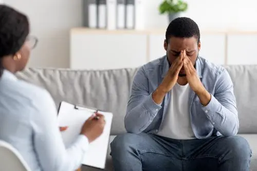 a-man-grieving-in-the-counselor-office